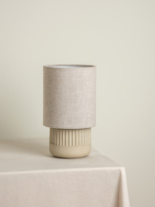 Enza - warm white ribbed concrete table lamp